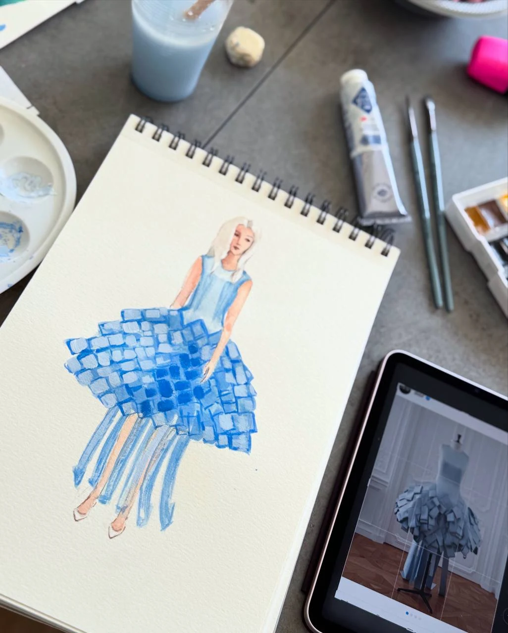Blue dress fashion illustration on Oksana's studio desk