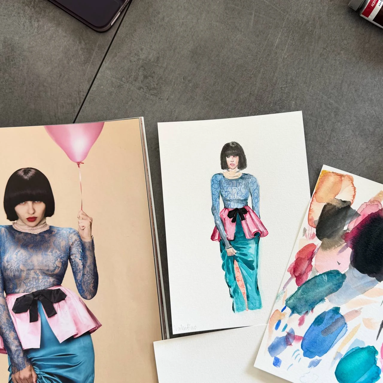 Colorful fashion studies spread across the studio desk